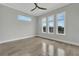 Bright bedroom with tile floors, a ceiling fan, and multiple windows at 5713 Tybee Island Dr, Apollo Beach, FL 33572