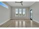 Spacious bedroom with tile floors, a ceiling fan, and large windows overlooking the water at 5713 Tybee Island Dr, Apollo Beach, FL 33572