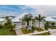 Beautiful two-story home with lush landscaping and a metal roof at 5713 Tybee Island Dr, Apollo Beach, FL 33572