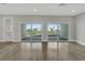 Bright living room with sliding glass doors leading to a spacious balcony and water views at 5713 Tybee Island Dr, Apollo Beach, FL 33572