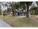 Ranch-style home with a gray exterior, stone accents, and a driveway at 7151 Pinewood Dr, New Port Richey, FL 34652