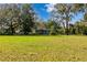 Ranch-style home with a large grassy yard and oak trees at 7313 Clayton Rd, Brooksville, FL 34601