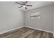 Bright bedroom with ceiling fan and wood-look flooring at 7801 Vienna Ln, Port Richey, FL 34668