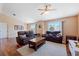 Bright living room with hardwood floors, comfortable seating and access to the dining area at 8455 Shallow Creek Ct, New Port Richey, FL 34653