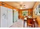 Bright dining area with wood paneled walls and a view to the backyard at 9220 N 29Th St, Tampa, FL 33612