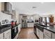 Modern kitchen featuring stainless steel appliances and a large island at 9615 Xenia St, New Port Richey, FL 34654