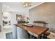 Dining room with a rustic wooden table and geometric wallpaper at 1002 S Moody Ave # 2, Tampa, FL 33629