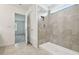 A tiled walk-in shower with a neutral color scheme and recessed storage in the bathroom at 10524 Hidden Banks Gln, Parrish, FL 34219