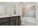 Bathroom features a single vanity with a modern dark wood finish and a tub and shower combo at 10524 Hidden Banks Gln, Parrish, FL 34219