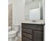 Bathroom features a single vanity with a modern dark wood finish and neutral wall color at 10524 Hidden Banks Gln, Parrish, FL 34219
