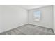 A naturally lit bedroom with neutral carpet and crisp white walls at 10524 Hidden Banks Gln, Parrish, FL 34219