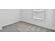 Clean, empty bedroom with gray carpet, white walls, and a window with blinds at 10524 Hidden Banks Gln, Parrish, FL 34219