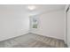 A naturally lit bedroom with neutral carpet and crisp white walls at 10524 Hidden Banks Gln, Parrish, FL 34219