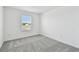 A naturally lit bedroom with neutral carpet and crisp white walls at 10524 Hidden Banks Gln, Parrish, FL 34219