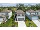 Aerial view of a modern two-story home with a well-manicured lawn and landscaping at 10524 Hidden Banks Gln, Parrish, FL 34219
