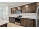 Kitchen with stainless steel appliances, subway tile backsplash, dark wood cabinets and light countertops at 10524 Hidden Banks Gln, Parrish, FL 34219