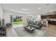 Bright living room featuring an open floor plan with a sliding glass door that leads to the backyard at 10524 Hidden Banks Gln, Parrish, FL 34219