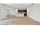 Open living space featuring hardwood floors, white walls, with kitchen access and lots of light at 10524 Hidden Banks Gln, Parrish, FL 34219