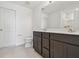 Bright bathroom features double vanity with dark cabinets and neutral-colored countertops at 10541 Hidden Banks Gln, Parrish, FL 34219