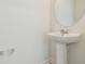 Modern pedestal sink in a well-lit half bathroom at 10541 Hidden Banks Gln, Parrish, FL 34219