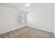 This bedroom features neutral carpet, a window with blinds, and bright white walls at 10541 Hidden Banks Gln, Parrish, FL 34219
