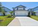 Charming two-story home featuring a well-manicured lawn and a spacious driveway at 10541 Hidden Banks Gln, Parrish, FL 34219