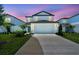 Charming two-story home with a well-maintained front yard and a two-car garage at 10541 Hidden Banks Gln, Parrish, FL 34219