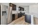 Well-lit kitchen with stainless steel appliances and dark cabinetry at 10541 Hidden Banks Gln, Parrish, FL 34219