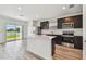 Open kitchen with stainless steel appliances, island, and a view at 10541 Hidden Banks Gln, Parrish, FL 34219