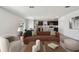Open-concept living room with sleek hardwood floors and modern furnishings at 10541 Hidden Banks Gln, Parrish, FL 34219