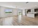 Open-concept living room with large windows and hardwood floors at 10541 Hidden Banks Gln, Parrish, FL 34219