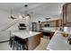 Modern kitchen featuring an island with seating, stainless steel appliances, and dark wood cabinetry at 11228 Shadybrook Dr, Tampa, FL 33625