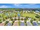 Community overview, showing homes, park, tennis courts, and a pond at 11416 Piedmont Park Xing, Bradenton, FL 34211