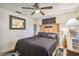 Cozy bedroom with wood bed frame and ceiling fan at 11815 Lakewood Dr, Hudson, FL 34669