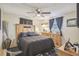 Bedroom with a wooden dresser, nightstand and ceiling fan at 11815 Lakewood Dr, Hudson, FL 34669