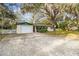 Front view of a ranch home with a large driveway at 11815 Lakewood Dr, Hudson, FL 34669