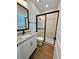 Stylish bathroom featuring a glass-enclosed shower, vanity sink and modern finishes at 13400 Haflinger Way, Hudson, FL 34667