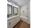 Elegant bathroom with a double sink vanity, decorative mirrors, and a tiled shower/tub combination at 13400 Haflinger Way, Hudson, FL 34667