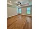 Bright bedroom featuring wood-look floors, a modern ceiling fan, recessed lights and two windows at 13400 Haflinger Way, Hudson, FL 34667