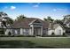 One-story home with stone accents and a three-car garage at 13400 Haflinger Way, Hudson, FL 34667
