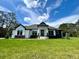 Beautiful single-story home with a manicured lawn and a modern, eye-catching exterior design at 13400 Haflinger Way, Hudson, FL 34667