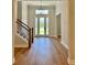 Inviting foyer with wood-look flooring, staircase and a large front door with glass inserts at 13400 Haflinger Way, Hudson, FL 34667
