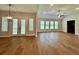 Open-plan living area featuring wood-look floors, recessed lighting, modern fixtures, and multiple windows at 13400 Haflinger Way, Hudson, FL 34667