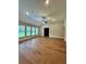 Well-lit living room featuring wood-look floors, recessed lighting, a ceiling fan and large windows at 13400 Haflinger Way, Hudson, FL 34667