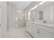 Elegant bathroom featuring double vanity and walk-in shower at 1532 Gopher Loop, Tarpon Springs, FL 34689