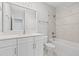 Clean bathroom with white vanity, bathtub, and shower at 1532 Gopher Loop, Tarpon Springs, FL 34689