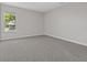 Well-lit bedroom featuring carpet and a window at 1532 Gopher Loop, Tarpon Springs, FL 34689