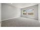 Bright bedroom with carpet flooring and two large windows at 1532 Gopher Loop, Tarpon Springs, FL 34689