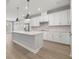 Modern kitchen with white cabinets, quartz countertops, and stainless steel appliances at 1532 Gopher Loop, Tarpon Springs, FL 34689