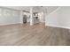 Open concept living room with hardwood floors and kitchen views at 1532 Gopher Loop, Tarpon Springs, FL 34689